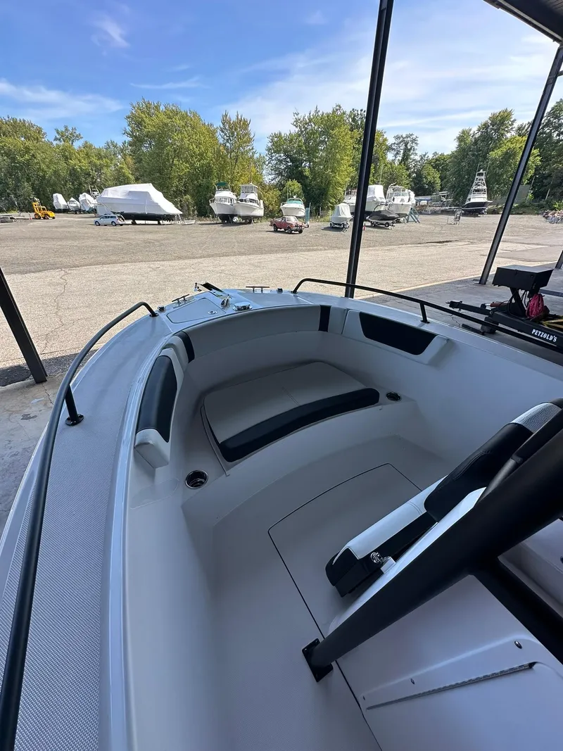 Slide: The Image of 2025 Edgewater 208CC Center Console boat interior with seating and steering wheel. - 15