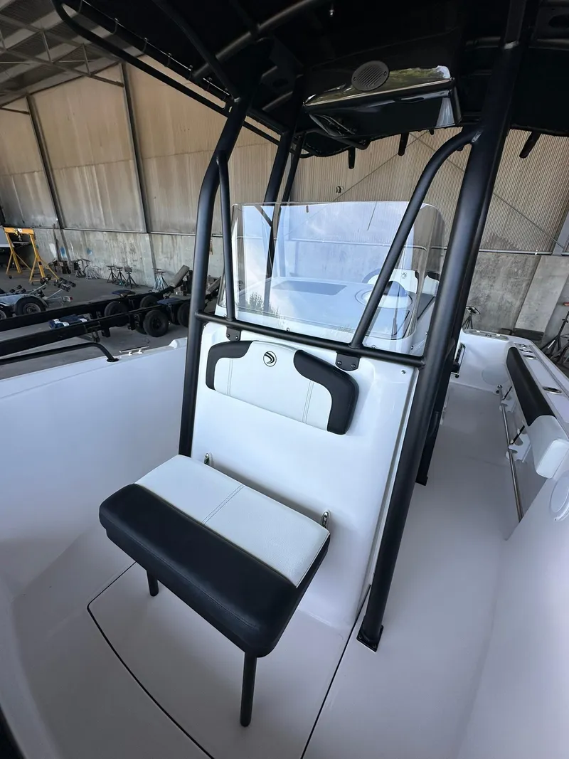 Slide: The Image of 2025 Edgewater 208CC Center Console boat interior with cushioned seating and storage. - 19