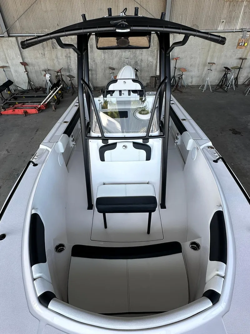 Slide: The Image of 2025 Edgewater 208CC Center Console boat interior in a warehouse setting. - 23