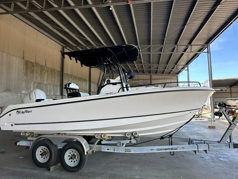 Slide: The Image of 2025 Edgewater 208CC Center Console boat on trailer in covered storage. - 4