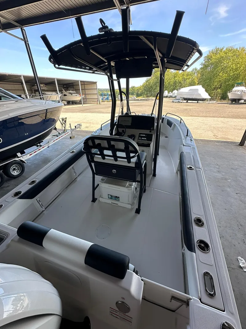 Slide: The Image of 2025 Edgewater 208CC Center Console boat with Yamaha engine in a covered storage area. - 6