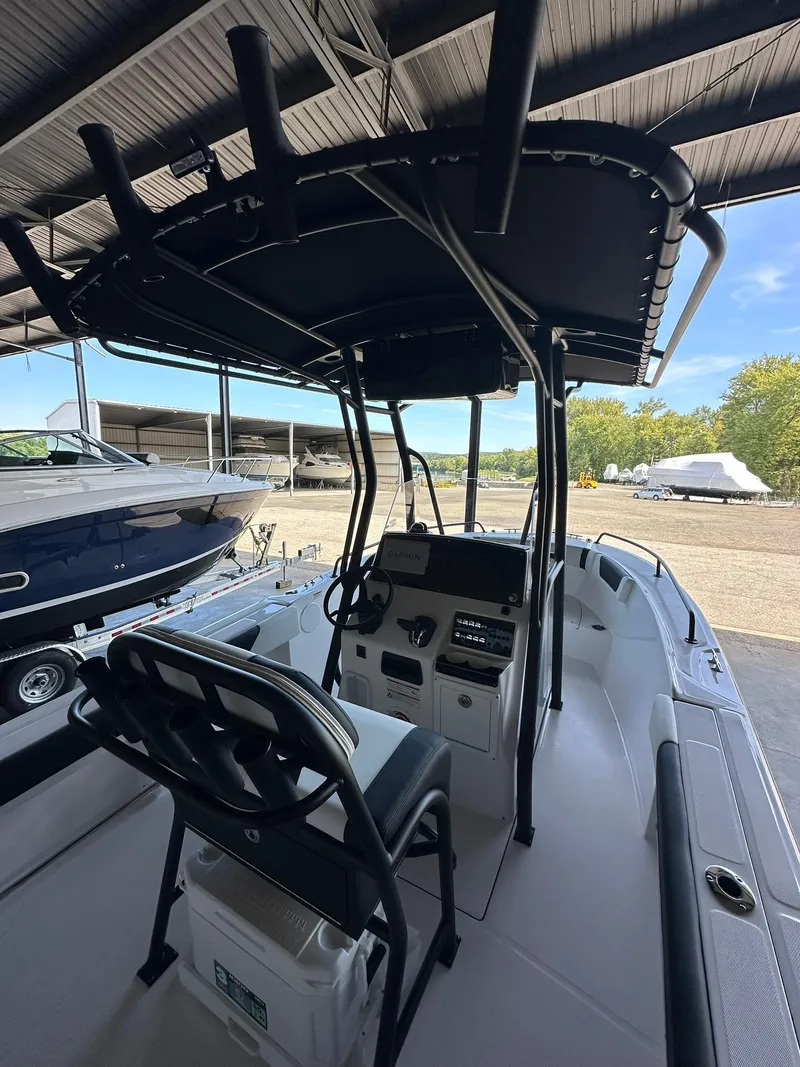 Slide: The Image of 2025 Edgewater 208CC Center Console boat in storage, featuring spacious deck and seating. - 9