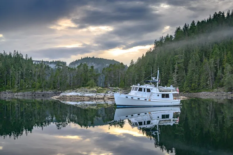 The Image of Krogen 44 AE yacht anchored in a serene forested lake, 2025 model. - 0