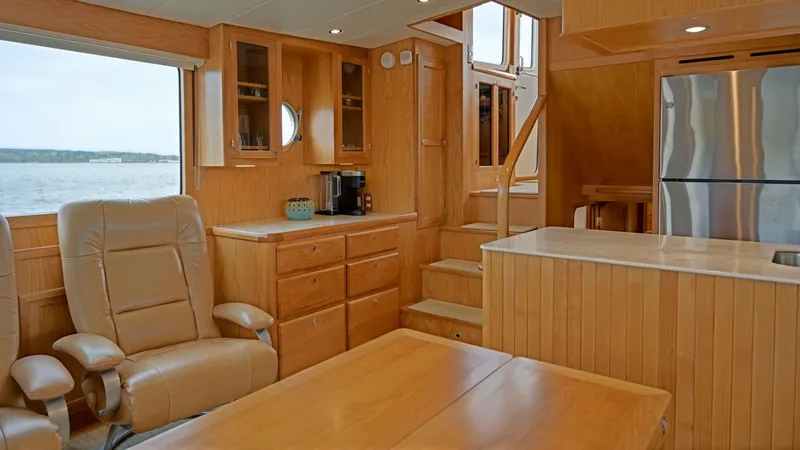 Slide: The Image of Interior of 2025 Krogen 44 AE yacht with wooden cabinetry and leather seating. - 3