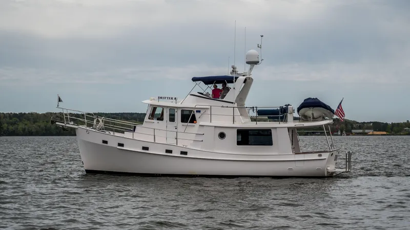 Slide: The Image of 2025 Krogen 44 AE yacht cruising on a calm lake. - 5