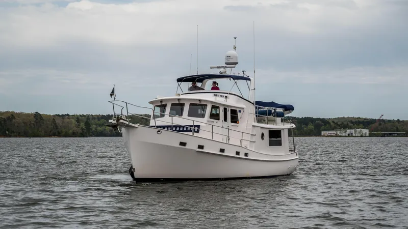 Slide: The Image of 2025 Krogen 44 AE yacht cruising on a calm lake. - 6