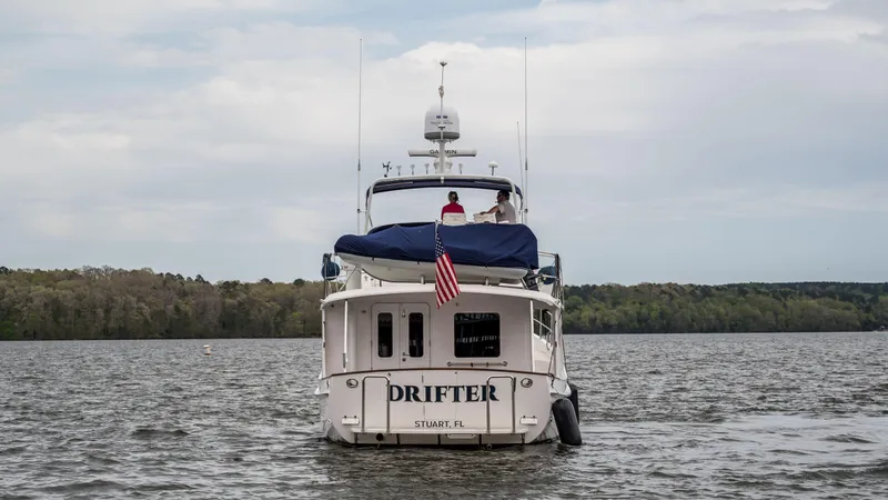 Slide: The Image of Krogen 44 AE 2025 yacht Drifter on a lake with American flag. - 7