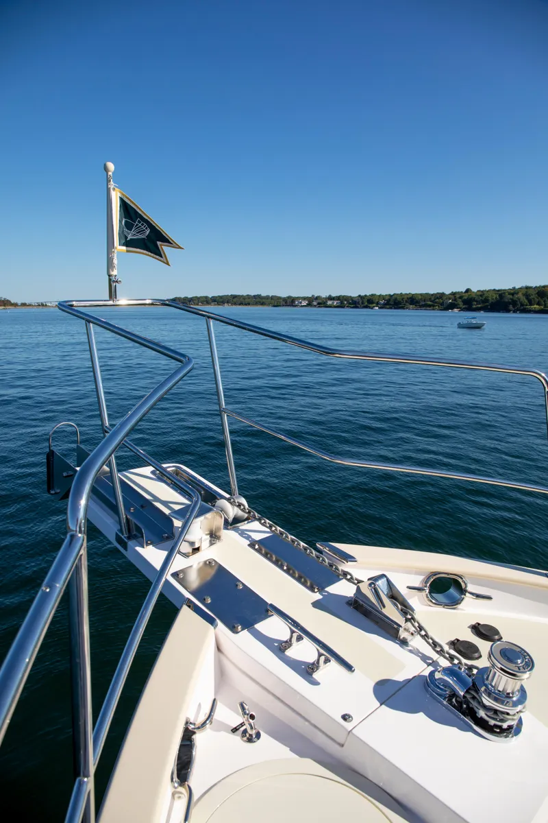 Slide: The Image of Bow of 2025 Krogen 48 AE yacht on calm water. - 12