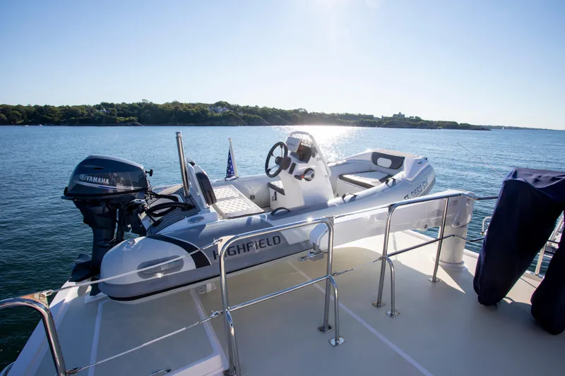 Slide: The Image of Krogen 48 AE 2025 model with Highfield tender on deck, scenic water backdrop. - 13