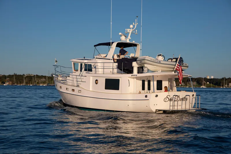 Slide: The Image of Krogen 48 AE 2025 yacht cruising on calm waters with clear blue sky. - 2