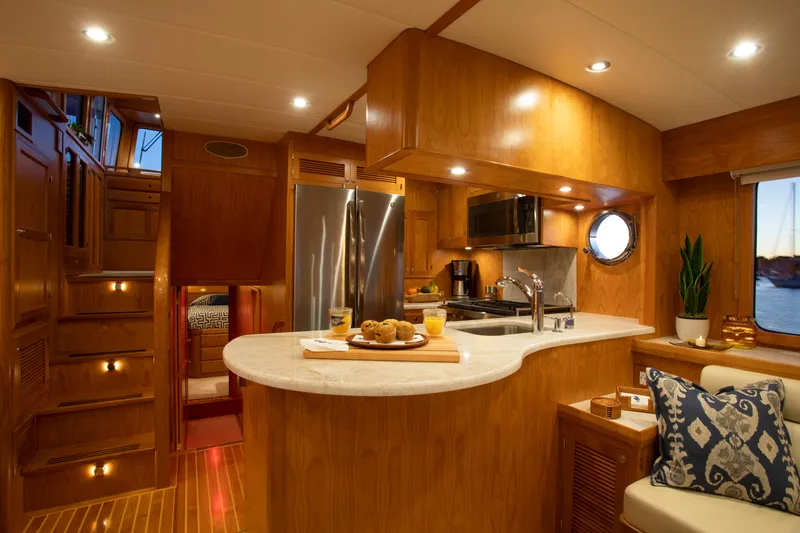 Slide: The Image of Luxurious interior of 2025 Krogen 48 AE yacht with modern kitchen and cozy seating area. - 6