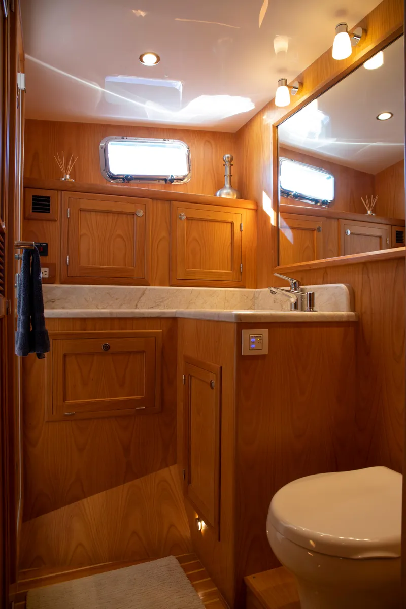 Slide: The Image of Luxurious bathroom in 2025 Krogen 48 AE yacht with wooden cabinetry and modern fixtures. - 8