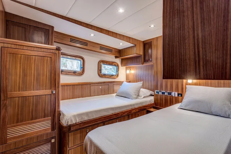 Slide: The Image of Luxurious cabin interior of 2026 Krogen 58 Extended Bridge yacht with twin beds and wood finish. - 11