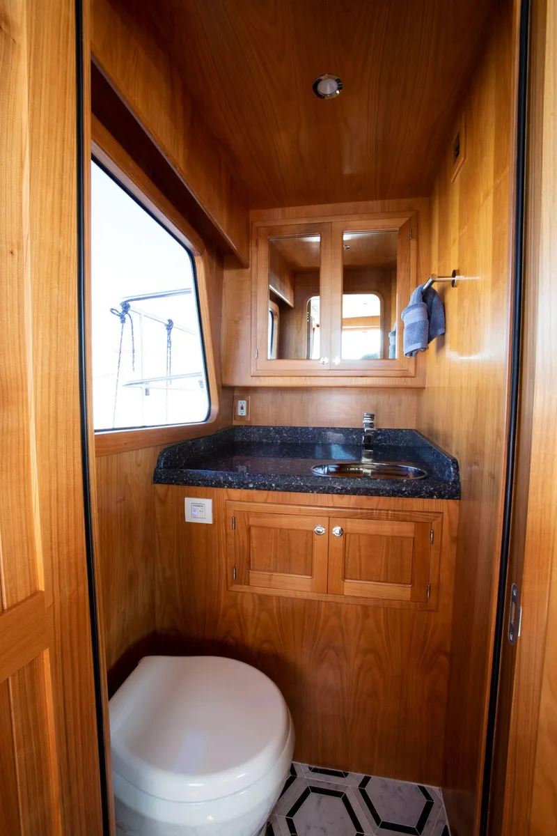 Slide: The Image of Luxurious bathroom in 2025 Krogen 58 Extended Bridge yacht with wood finish and modern fixtures. - 21