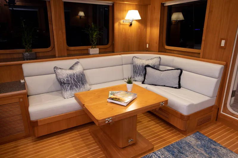 Slide: The Image of Luxurious interior of 2025 Krogen 58 Extended Bridge yacht with elegant seating and wooden table. - 23