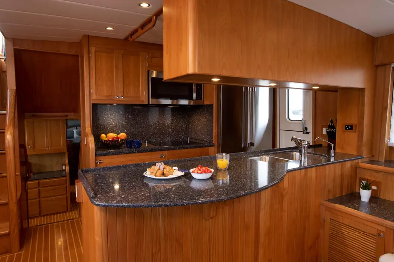 Slide: The Image of Luxurious kitchen interior of 2025 Krogen 58 Extended Bridge yacht with wooden cabinetry. - 25