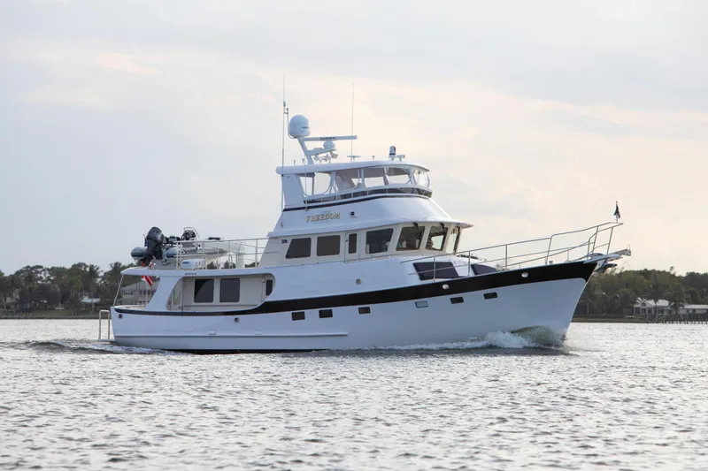 Slide: The Image of 2025 Krogen 58 Extended Bridge yacht cruising on calm waters. - 34