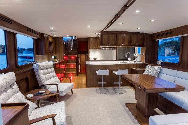 Slide: The Image of Luxurious interior of 2026 Krogen 58 Extended Bridge yacht with modern kitchen and seating area. - 6