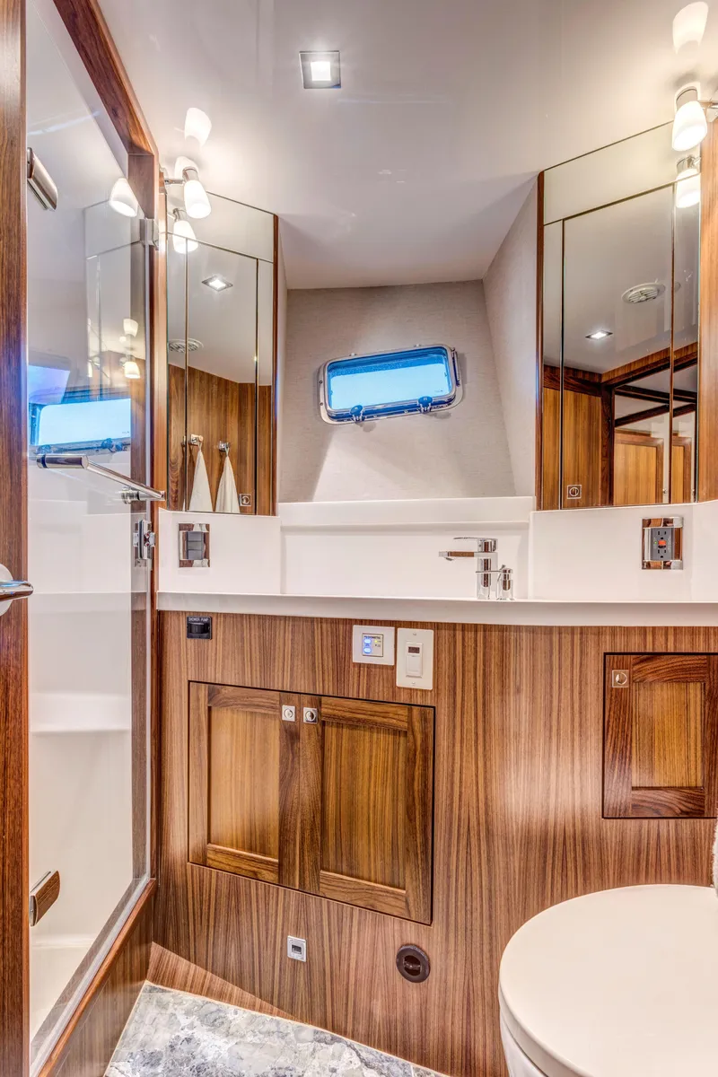 Slide: The Image of Luxurious bathroom in 2026 Krogen 58 Extended Bridge yacht, featuring elegant wood finishes and modern fixtures. - 9