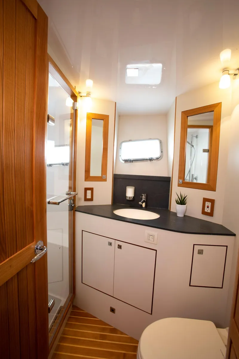 Slide: The Image of Modern bathroom in 2025 Krogen 52 yacht with wooden accents and sleek fixtures. - 11