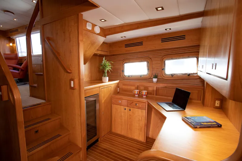 Slide: The Image of Modern interior of 2025 Krogen 52 yacht with wooden finish and workspace. - 12
