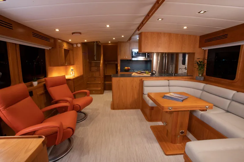 Slide: The Image of Luxurious interior of 2025 Krogen 52 yacht with modern kitchen and comfortable seating. - 5