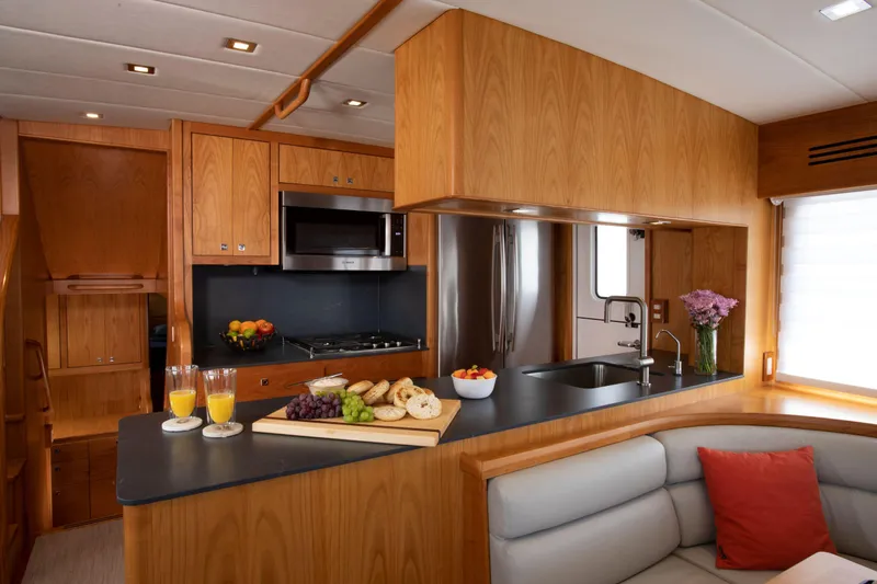 Slide: The Image of Modern kitchen in 2025 Krogen 52 yacht with stainless steel appliances and wooden cabinetry. - 7