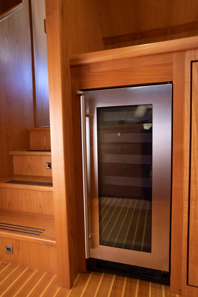 Slide: The Image of Modern interior of Krogen 52 yacht (2025) with built-in stainless steel wine cooler. - 8