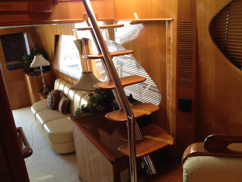 Slide: The Image of Luxurious interior of 2004 Ocean Alexander 548 Pilothouse yacht with wooden staircase and leather seating. - 10
