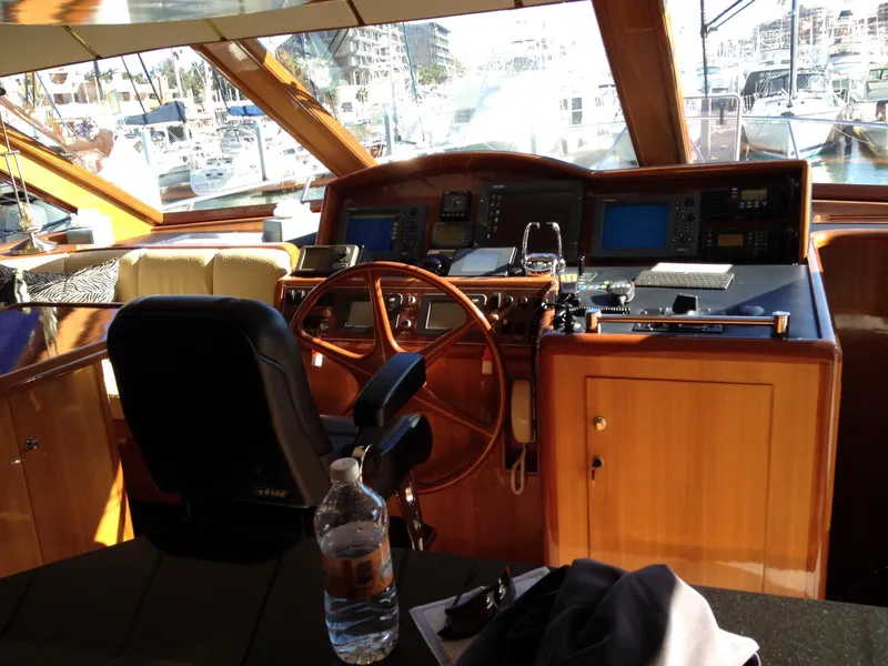 Slide: The Image of Pilothouse of 2004 Ocean Alexander 548 yacht with wooden steering wheel and navigation equipment. - 11