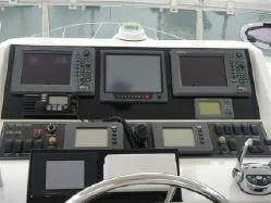 Slide: The Image of 2004 Ocean Alexander 548 Pilothouse helm with navigation and control systems. - 25