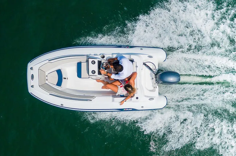 Slide: The Image of 2024 AB Inflatables Nautilus 12 DLX cruising on water, aerial view. - 4