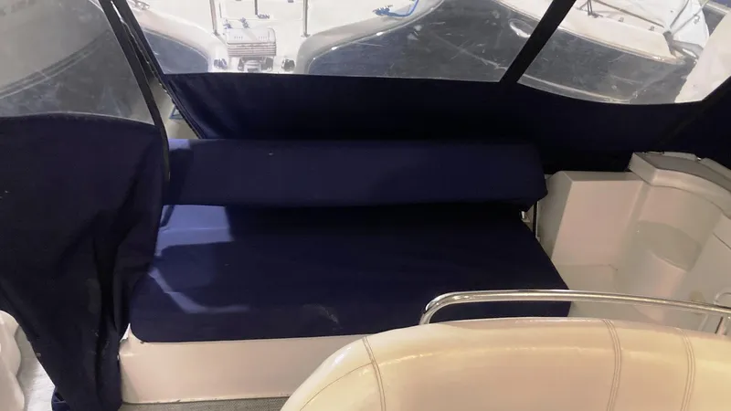 Slide: The Image of 2008 Regal 3760 boat interior with blue seating and protective cover. - 13