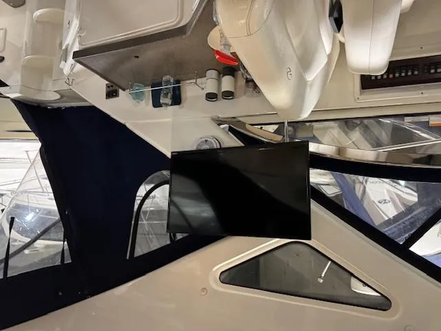 Slide: The Image of Interior of a 2008 Regal 3760 boat with mounted TV and seating area. - 14