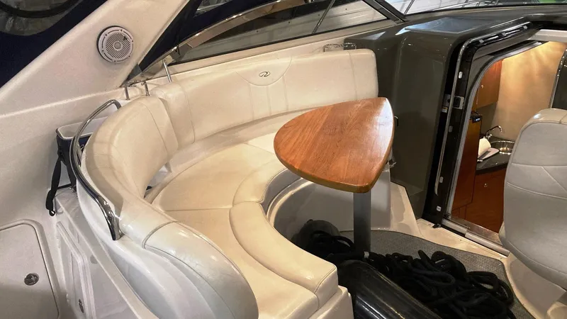 Slide: The Image of 2008 Regal 3760 yacht interior with curved seating and wooden table. - 15