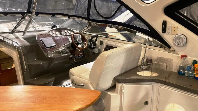 Slide: The Image of Interior of a 2008 Regal 3760 yacht with helm, seating, and kitchenette. - 17