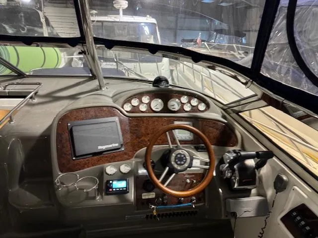 Slide: The Image of 2008 Regal 3760 boat helm with wooden steering wheel and navigation instruments. - 20