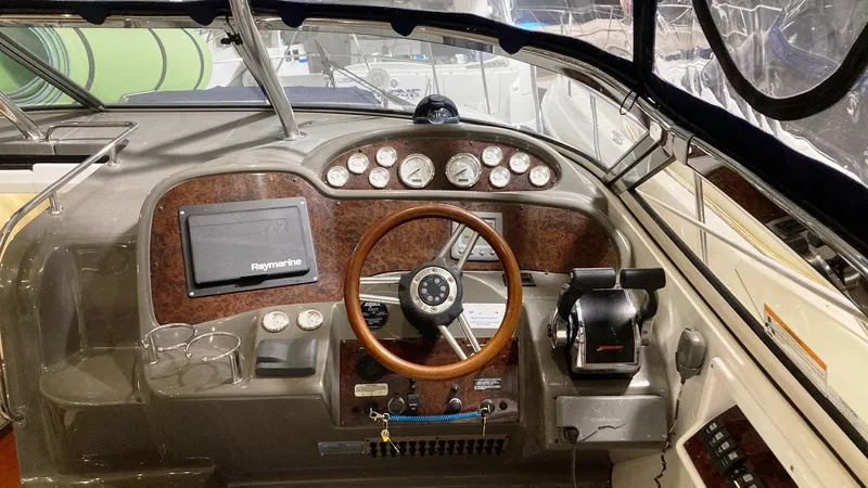 Slide: The Image of 2008 Regal 3760 boat dashboard with steering wheel, gauges, and navigation equipment. - 21