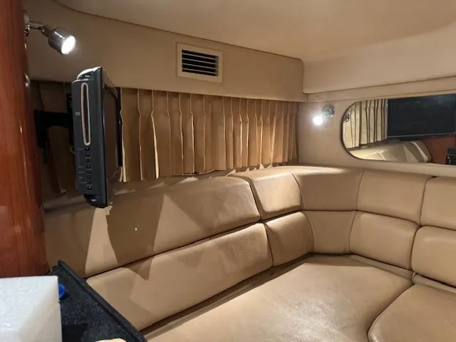Slide: The Image of Interior of 2008 Regal 3760 yacht with beige leather seating and mounted TV. - 27
