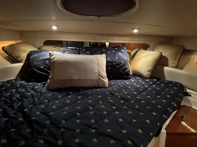 Slide: The Image of Luxurious cabin bed in a 2008 Regal 3760 yacht with star-patterned bedding. - 28