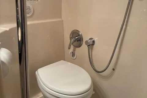 Slide: The Image of 2008 Regal 3760 boat bathroom with toilet and shower. - 30