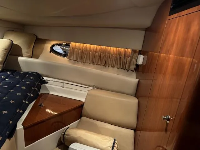 Slide: The Image of Interior cabin of a 2008 Regal 3760 yacht with wood paneling and seating. - 31
