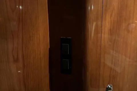 Slide: The Image of Wooden interior panel with light switches on a 2008 Regal 3760 boat. - 34