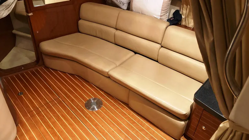 Slide: The Image of 2008 Regal 3760 yacht interior with beige leather seating and wooden flooring. - 35