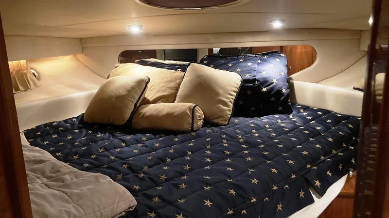 Slide: The Image of Luxurious cabin interior of a 2008 Regal 3760 yacht with cozy bedding. - 36