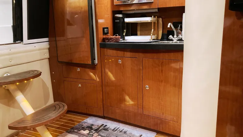 Slide: The Image of 2008 Regal 3760 yacht interior kitchen with wooden cabinets and steps. - 39