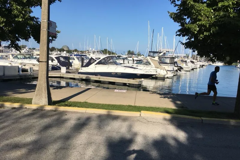 Slide: The Image of Marina with a 2008 Regal 3760 boat docked, runner on the sidewalk, sunny day. - 5