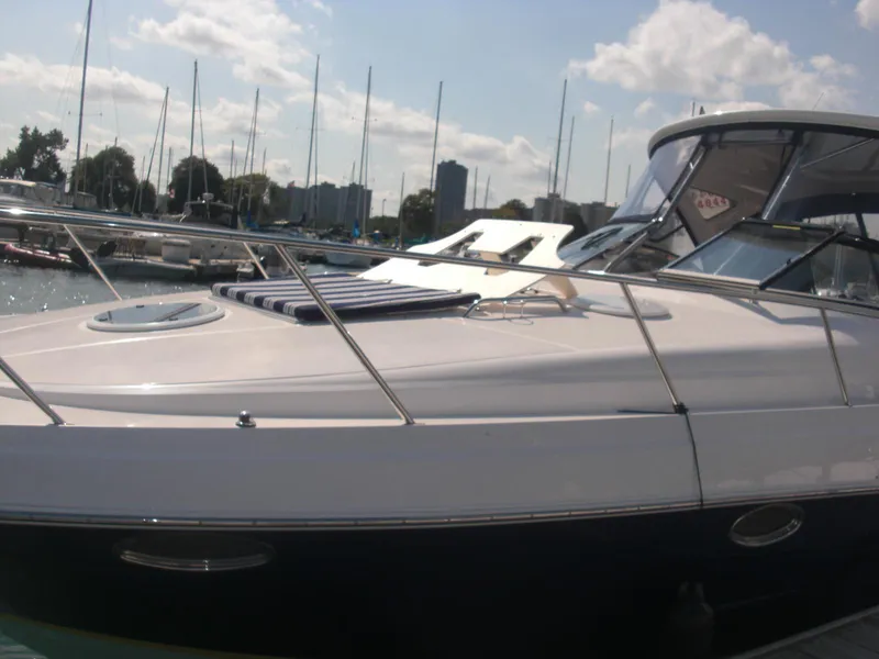 Slide: The Image of 2008 Regal 3760 yacht docked at marina with city skyline in background. - 8