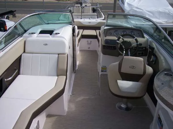 Slide: The Image of 2014 Regal 24 FasDeck boat interior with beige seating and modern dashboard. - 11