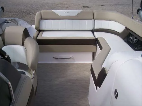 Slide: The Image of Interior seating of a 2014 Regal 24 FasDeck boat, featuring beige and white upholstery. - 12